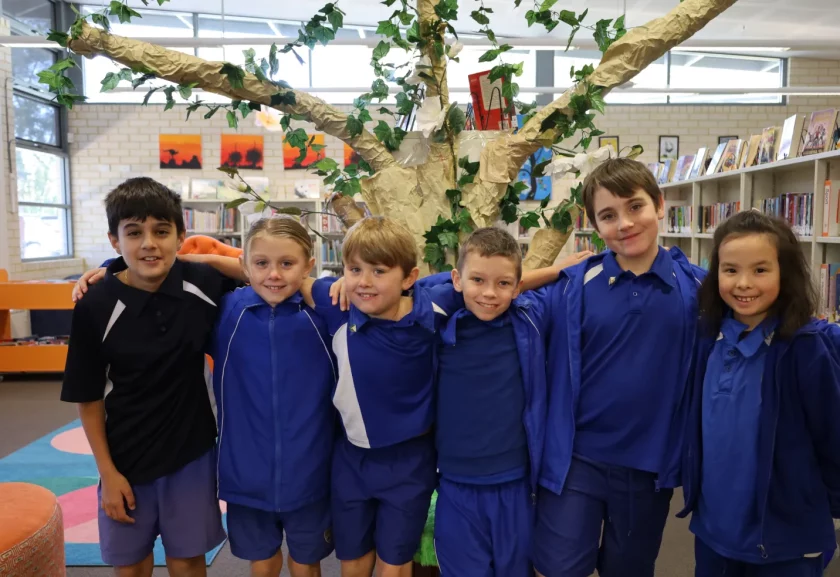 Group of children supporting each other in library