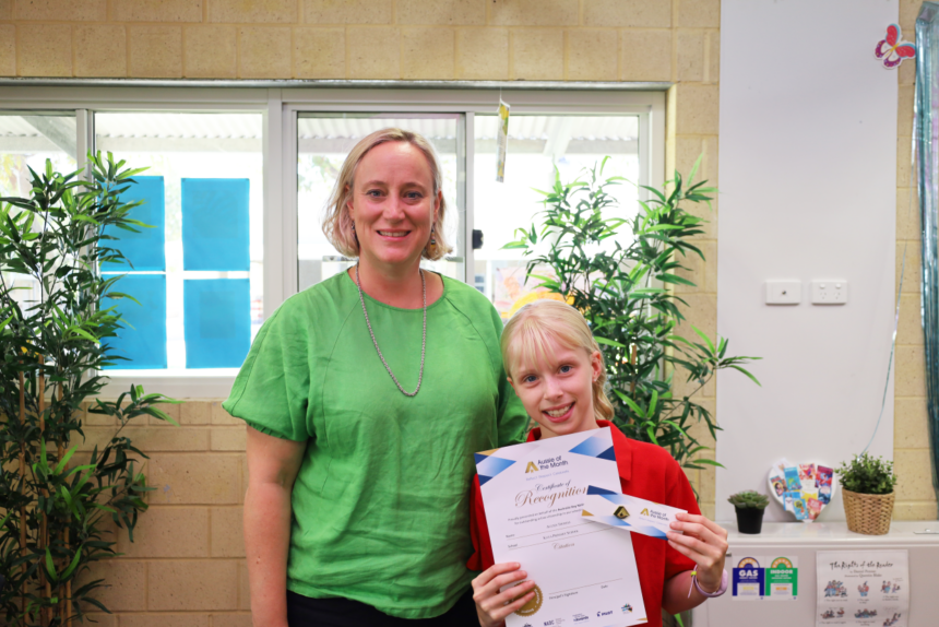 woman and girl holding certificate