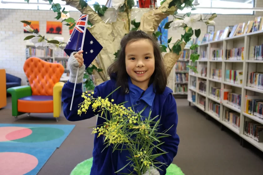 Girl holding flag and flowers