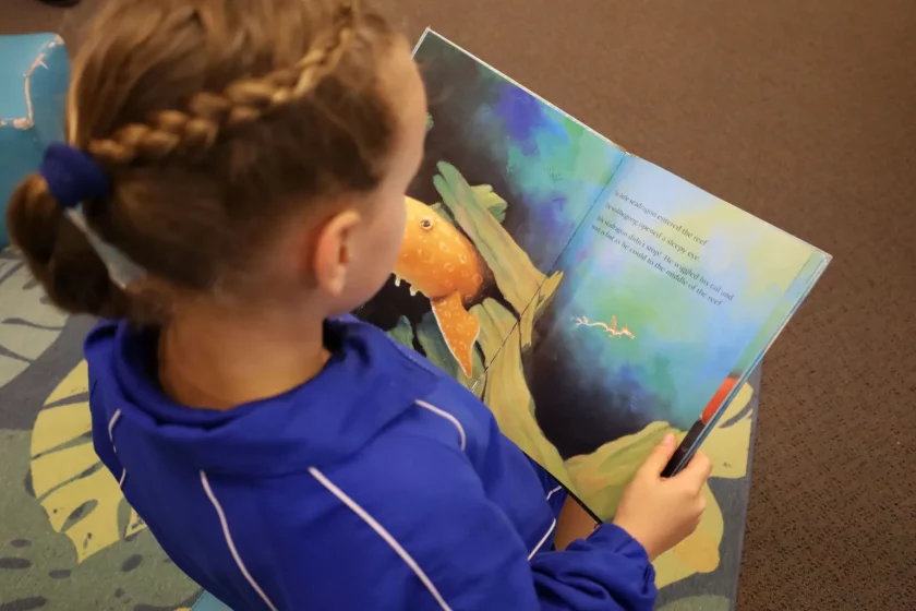 young girl reading book