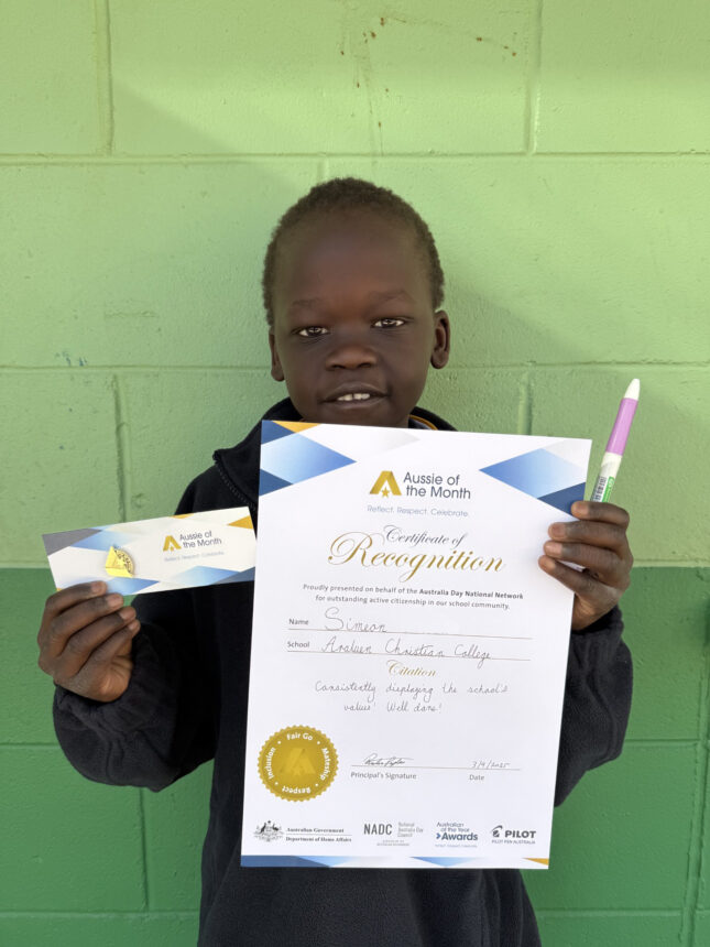 boy student holding certificate and smiling to camera