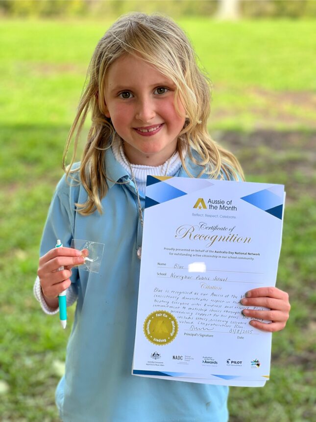 girl holding certificate and smiling to camera