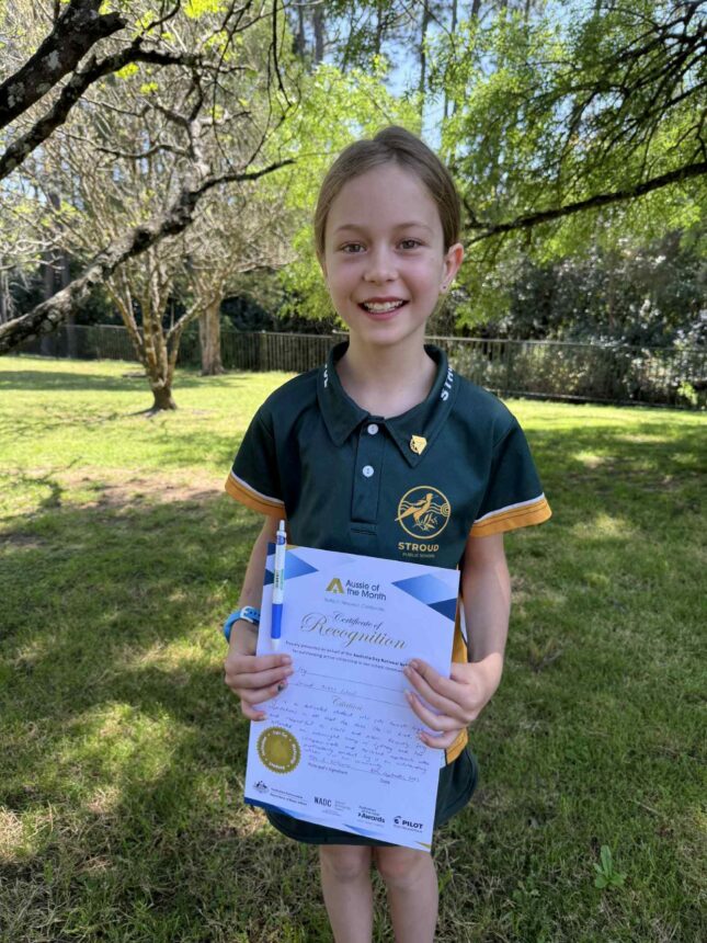 girl holding certificate and smiling to camera