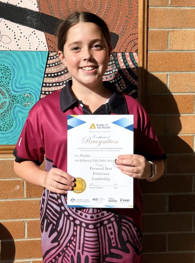 girl holding certificate and smiling to camera