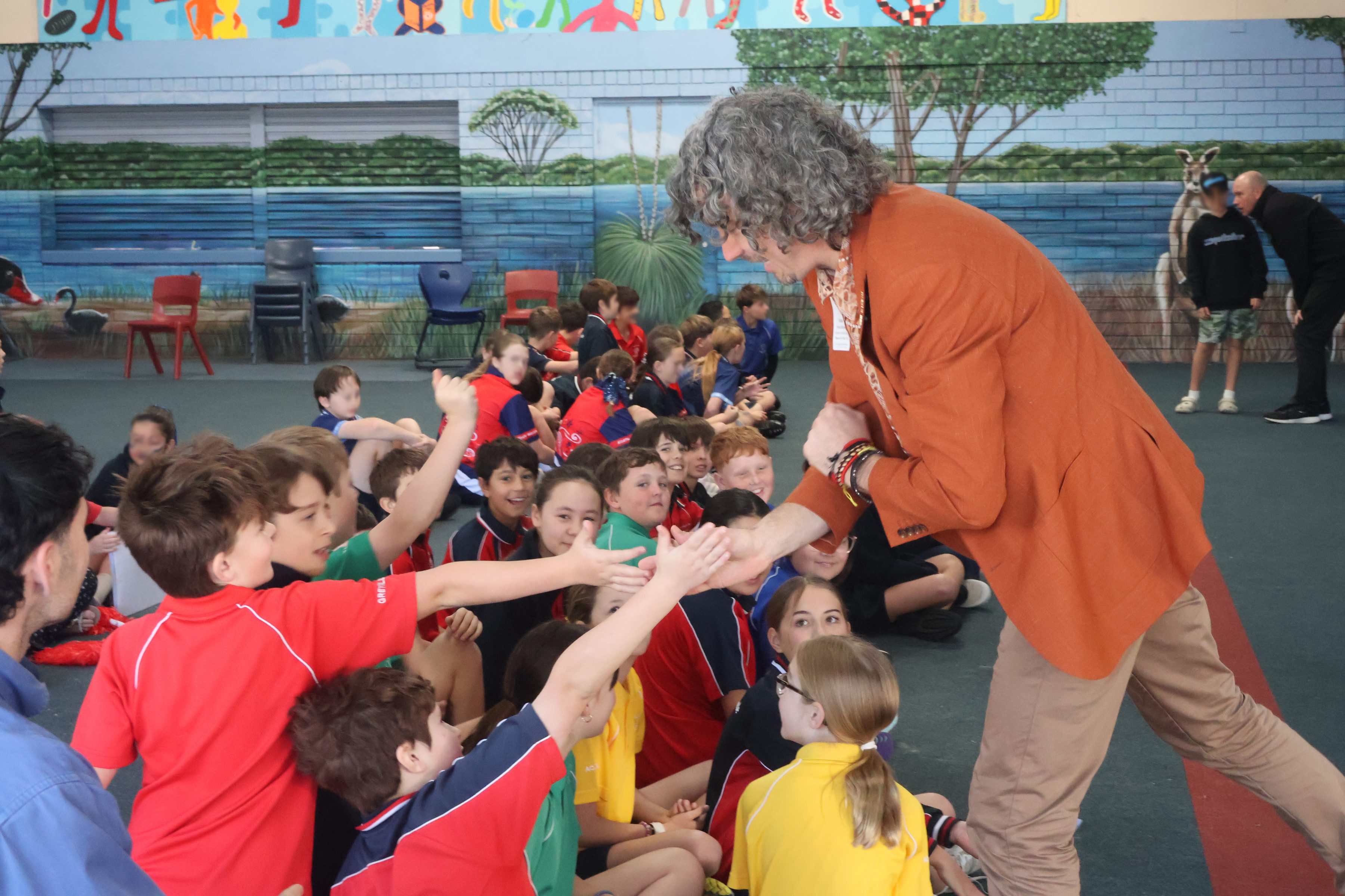 Frank Mitchell high fiving students